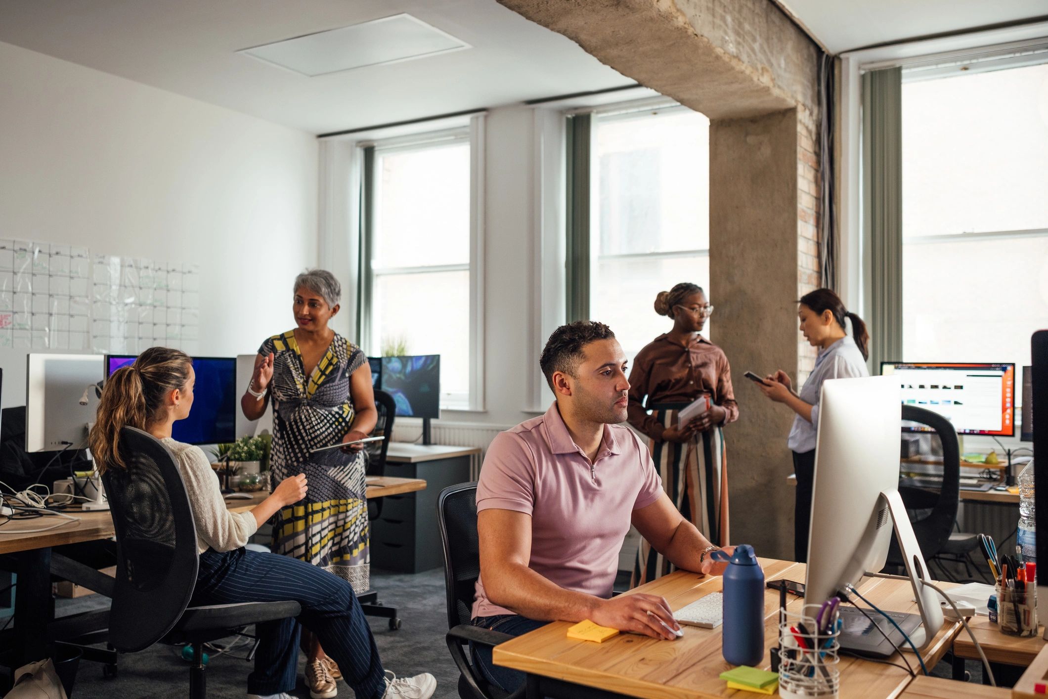 Professionals working together in a collaborative office