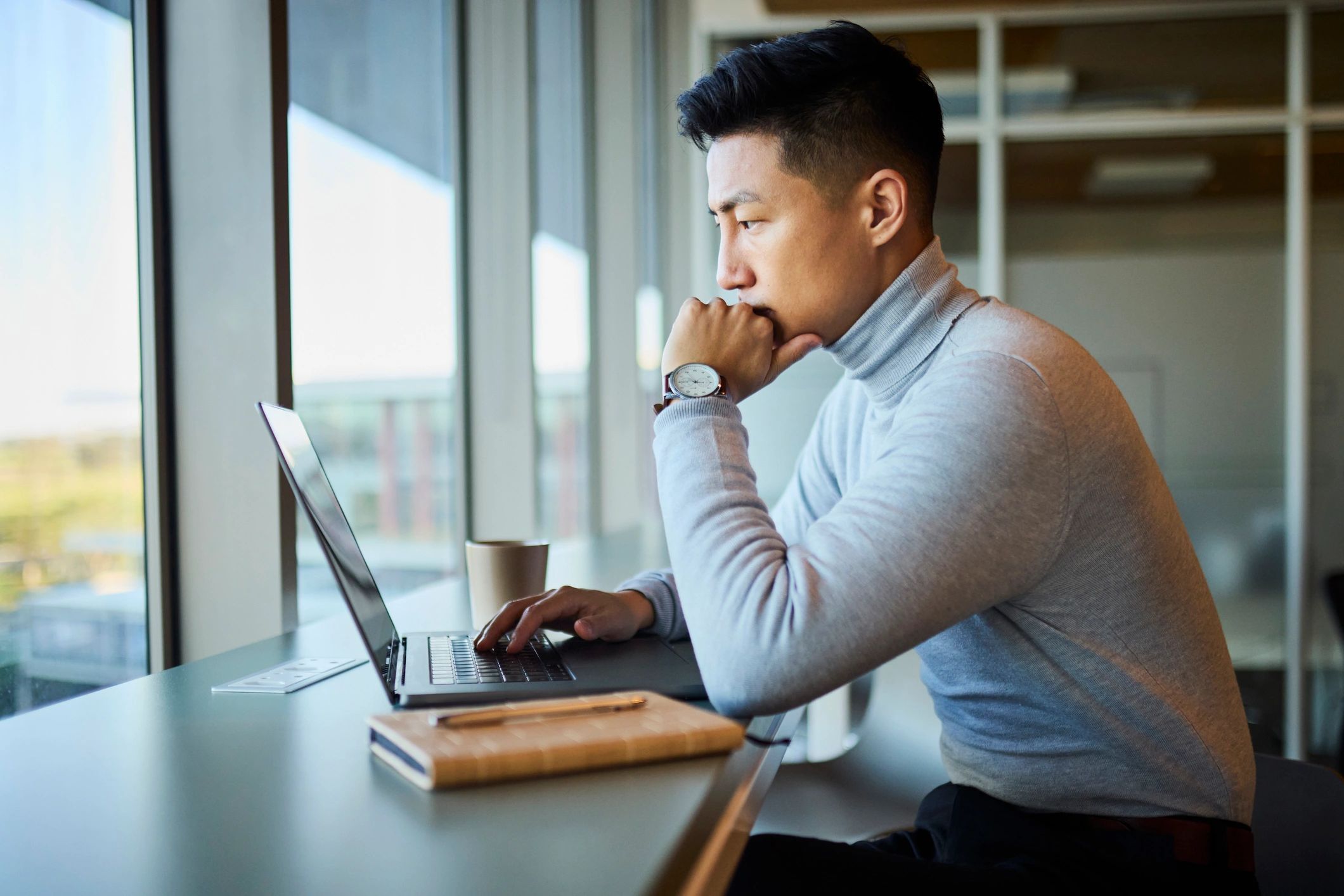Professional working on a laptop with focused attention
